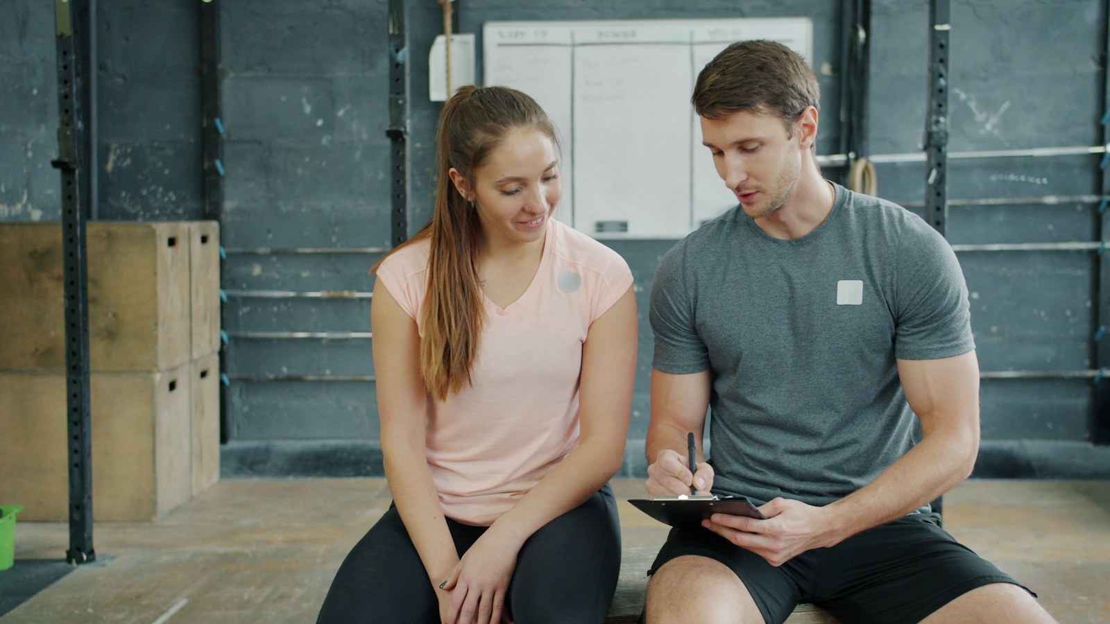A coach reviewing a plan with a gym client